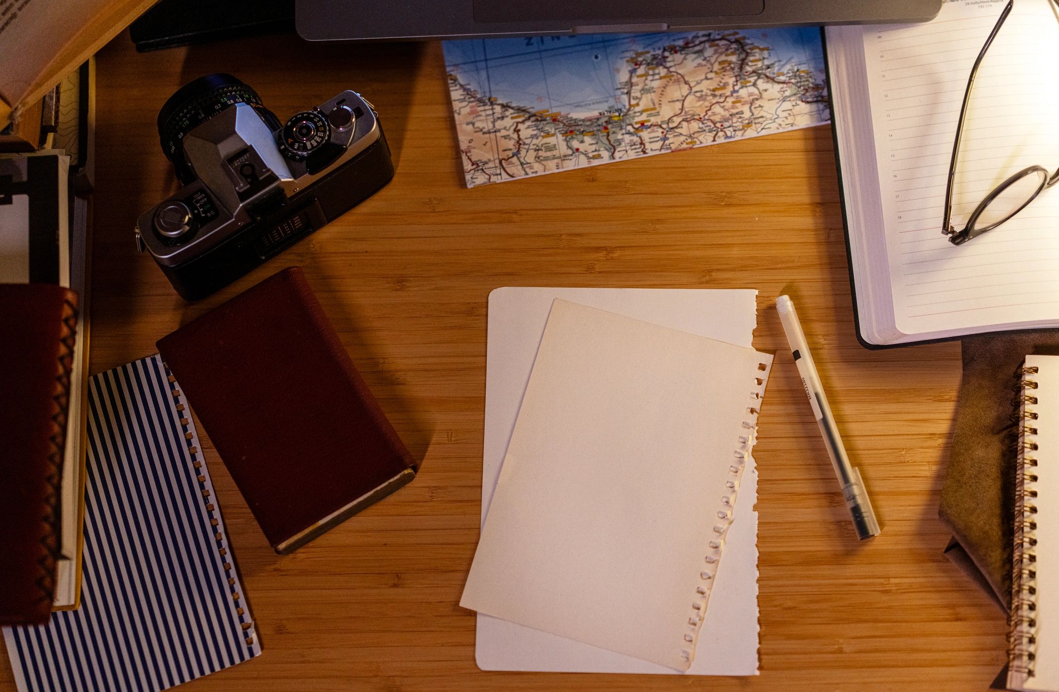 A tabletop with a vintage camera and keepsakes, suggesting memory keeping